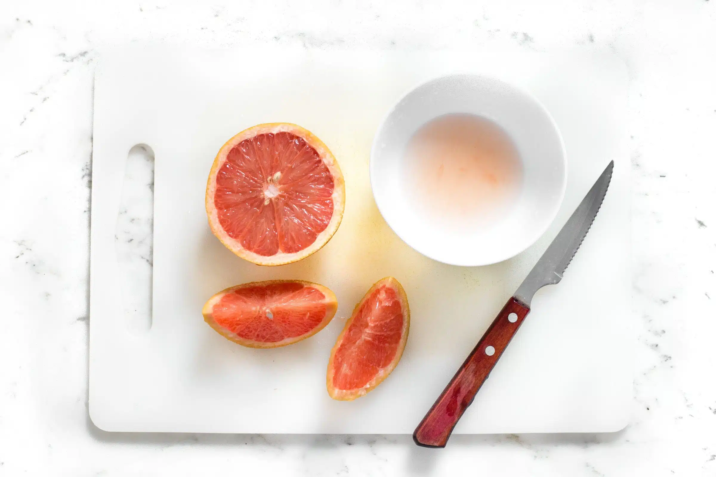 image of cut grapefruit on cutting board