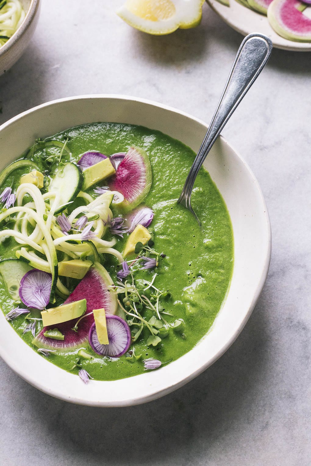 image of a bowl of chilled herb and cucumber soup with garnish on top